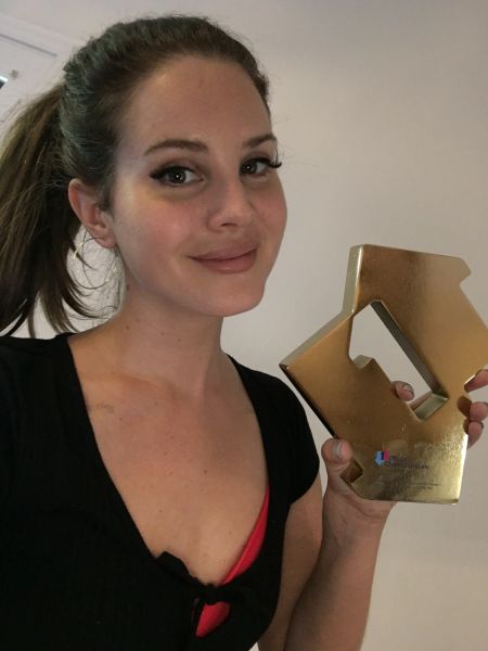 Lana Del Rey with her Official Number 1 Album Award for Norman F**king Rockwell (credit: OfficialCharts.com)